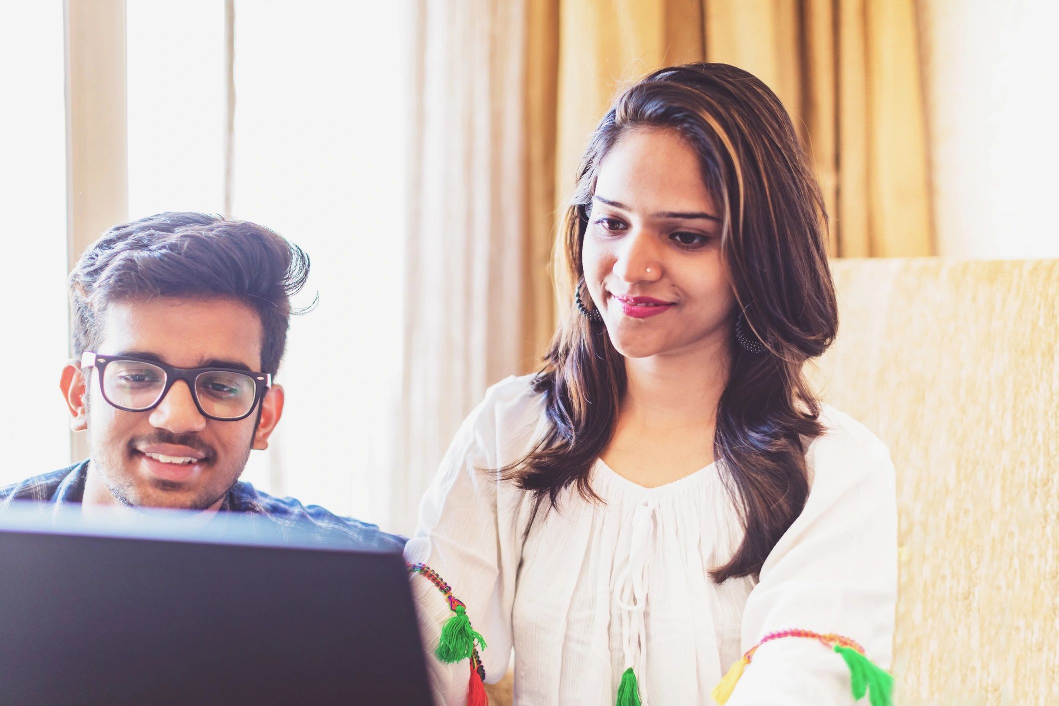 Young professionals reviewing work on a laptop