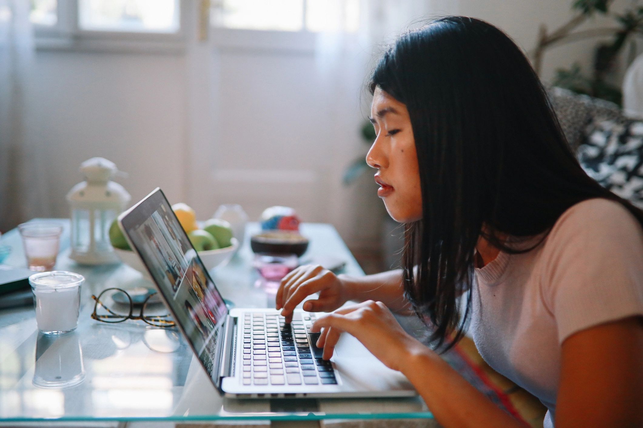 Young professional working on a laptop to prepare a resume