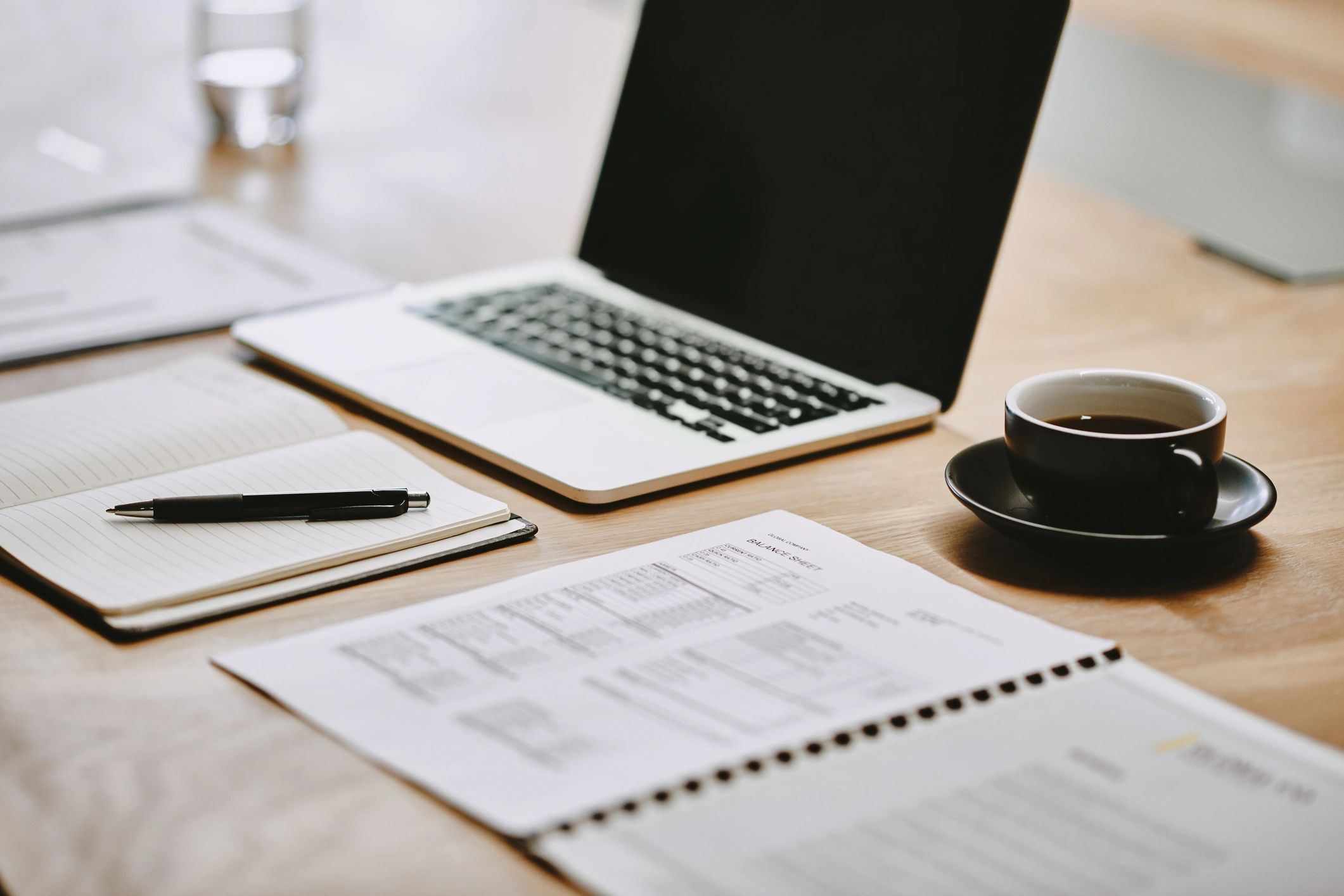 Professional workspace with laptop and notebook