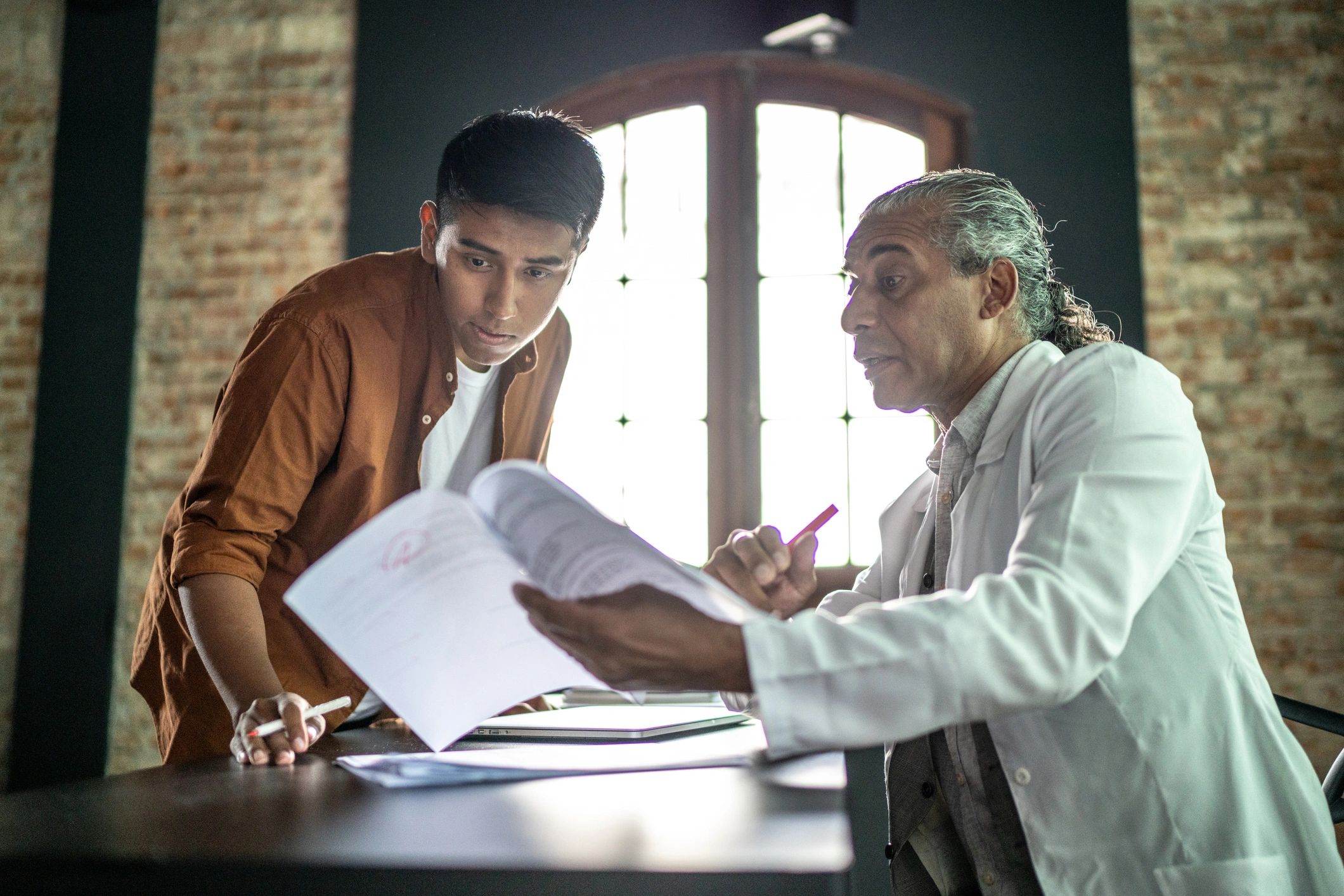 Career advisor helping a student at a desk
