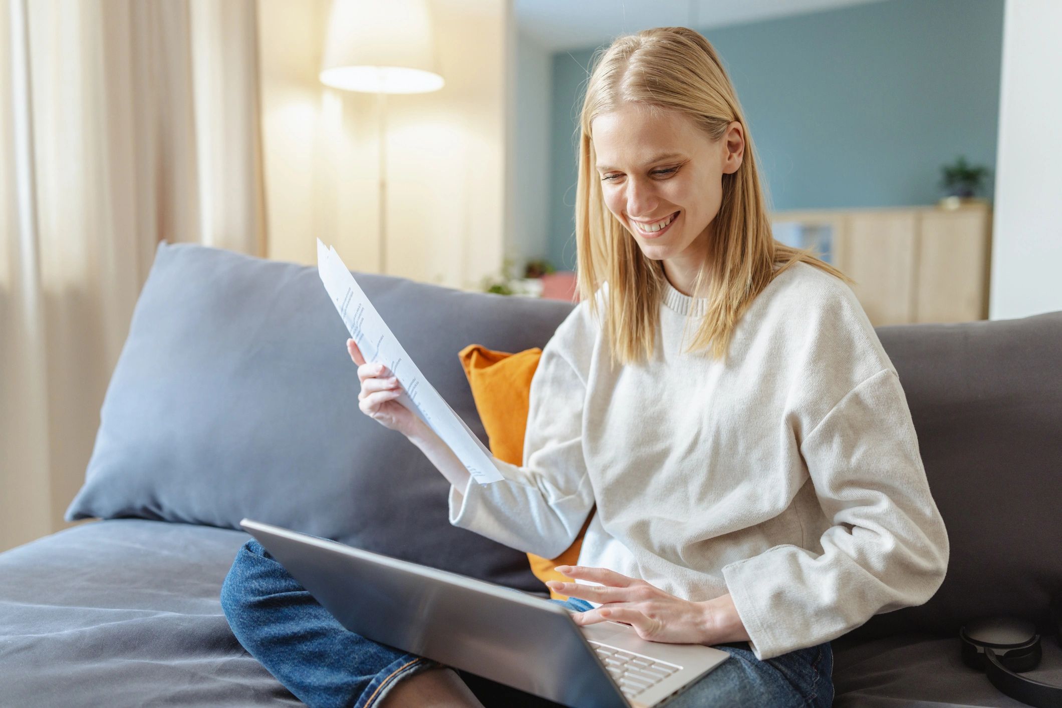 Young professional reviewing application documents on a laptop
