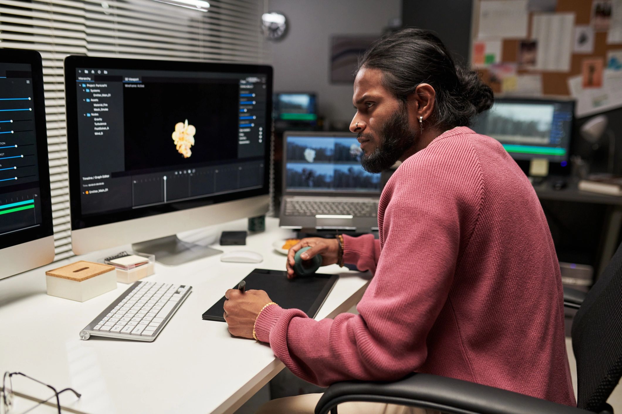 Young professional working at a digital workstation